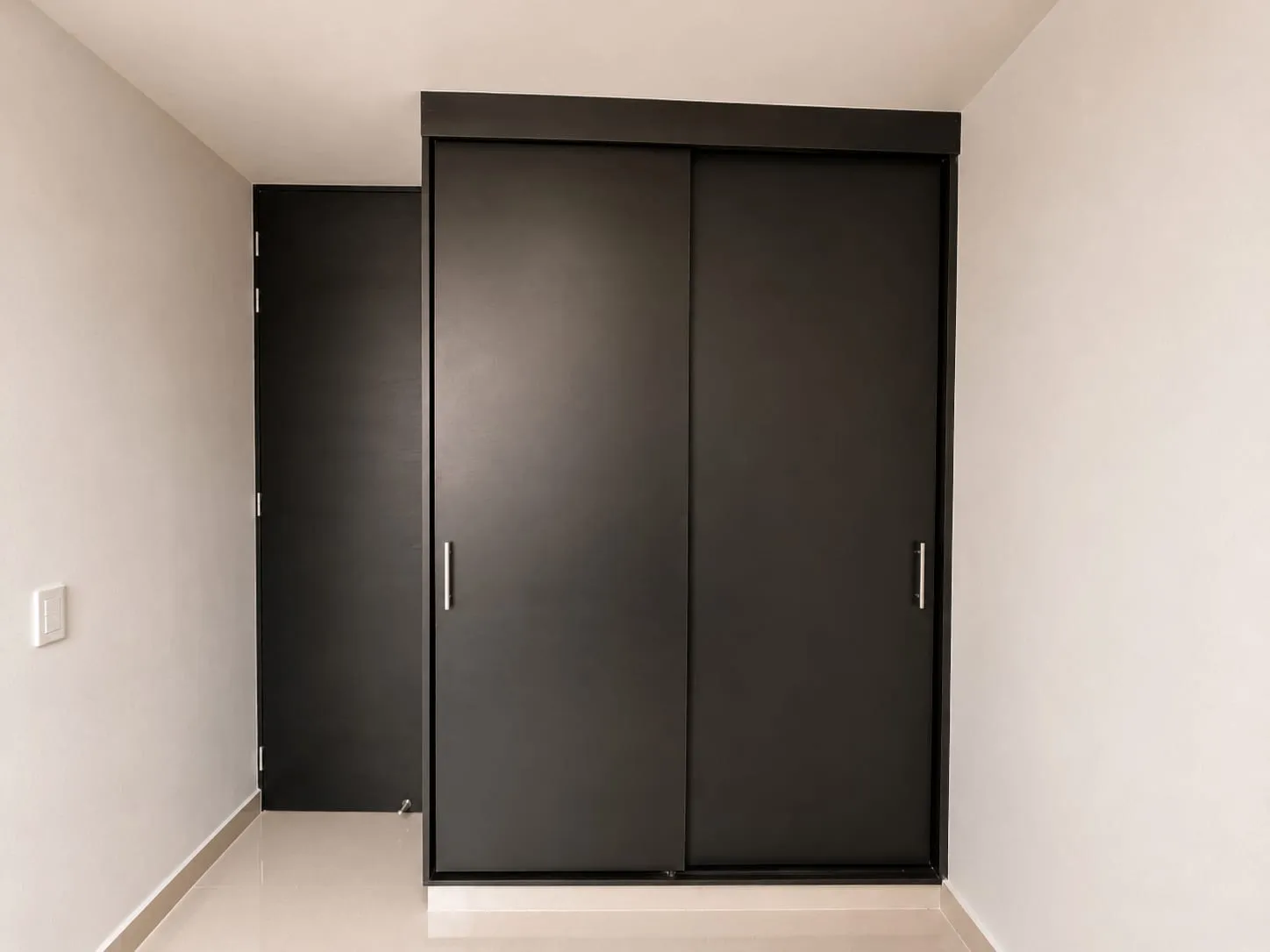 Una habitación secundaria con líneas depuradas y presencia refinada, donde la sobriedad del diseño transmite una terminación impecable y una sensación de alto nivel.